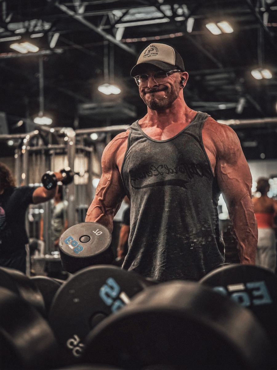 Adam Solis mid-set with a 70 lb dumbbell